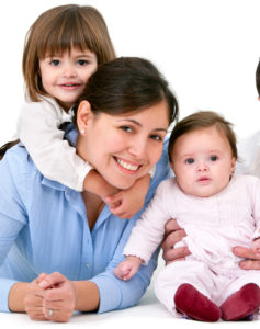 Portrait of young couple having fun with their daughters. Isolated on white background.